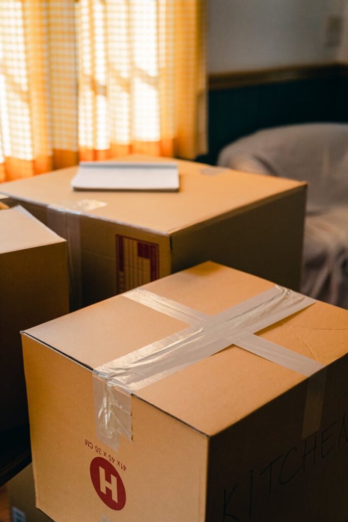 Sunlit room with cardboard boxes, indicating a move or delivery process.